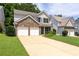 Traditional two-story home with brick facade, two-car garage, and well-manicured lawn at 167 Diamond Ridge Ave, Canton, GA 30114
