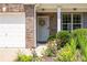 A cozy front entrance with a light blue door, surrounded by colorful flower beds, and lush greenery at 167 Diamond Ridge Ave, Canton, GA 30114