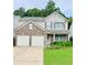 Charming two-story home features a brick facade, attached two-car garage, and beautifully landscaped front yard at 167 Diamond Ridge Ave, Canton, GA 30114