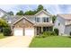 Charming two-story home featuring a brick facade, gray shutters, a two-car garage, and a well-manicured front yard at 167 Diamond Ridge Ave, Canton, GA 30114