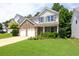 Inviting two-story home featuring a brick facade, gray shutters, a two-car garage, and lush green lawn at 167 Diamond Ridge Ave, Canton, GA 30114