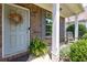 Cozy front porch with a light blue door and a rocking chair next to vibrant greenery at 167 Diamond Ridge Ave, Canton, GA 30114