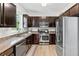 Well-equipped kitchen featuring dark cabinets, stainless steel appliances, and a functional layout at 167 Diamond Ridge Ave, Canton, GA 30114
