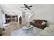 Open-concept living room showcasing hardwood floors, dark furnishings, and seamless flow into the kitchen at 167 Diamond Ridge Ave, Canton, GA 30114