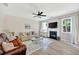Inviting living room with a cozy fireplace, a ceiling fan, and bright natural light through the windows at 167 Diamond Ridge Ave, Canton, GA 30114