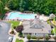 Aerial view of community pool, lounge area, and clubhouse surrounded by lush greenery at 167 Diamond Ridge Ave, Canton, GA 30114