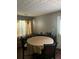 Inviting dining room with a round table and natural light from the window at 1793 Cutters Mill Way, Lithonia, GA 30058