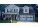 Charming two-story home with a brick facade, covered porch, and two-car garage at 1793 Cutters Mill Way, Lithonia, GA 30058