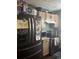 Practical kitchen with black appliances and tan cabinetry at 1793 Cutters Mill Way, Lithonia, GA 30058