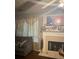 Relaxing living room featuring a fireplace and large windows with curtains at 1793 Cutters Mill Way, Lithonia, GA 30058