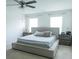 This bedroom features neutral carpet, a platform bed with a patterned comforter, and bright windows at 2159 Redfern Rd, Dacula, GA 30019
