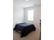 This bedroom features neutral carpet, a bed with a blue comforter, and a bright window at 2159 Redfern Rd, Dacula, GA 30019