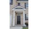 Close-up of the front door with white trim, black door, and 'welcome' sign at 2159 Redfern Rd, Dacula, GA 30019