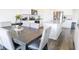 Open kitchen layout with a dining table, granite island, stainless steel appliances, and dark hardwood floors at 2159 Redfern Rd, Dacula, GA 30019