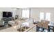 Open-concept living and dining area with a large sectional sofa, tv, and granite countertops at 2159 Redfern Rd, Dacula, GA 30019