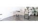 Modern office setup with a sleek desk, minimalist decor, and wood-look floors at 2159 Redfern Rd, Dacula, GA 30019