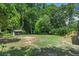 The backyard with lush green trees surrounding a small shed-style building at 6456 Wright Ne Rd, Atlanta, GA 30328
