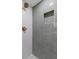 Modern bathroom featuring green tiled walls, gold fixtures, and a convenient shower niche at 6456 Wright Ne Rd, Atlanta, GA 30328