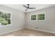 Neutral bedroom featuring hardwood floors, ceiling fan, and an abundance of natural light at 6456 Wright Ne Rd, Atlanta, GA 30328