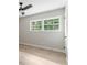 Neutral bedroom featuring hardwood floors, ceiling fan, and an abundance of natural light at 6456 Wright Ne Rd, Atlanta, GA 30328