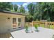 Beautiful deck with a table and chairs outside white-bricked house surrounded by greenery at 6456 Wright Ne Rd, Atlanta, GA 30328