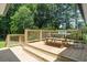 The back porch area features a wooden deck with an outdoor dining setup surrounded by lush greenery at 6456 Wright Ne Rd, Atlanta, GA 30328