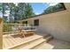 Outdoor deck with dining table and chairs perfect for entertaining with a view of lush green trees at 6456 Wright Ne Rd, Atlanta, GA 30328