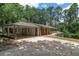 A single-story home with a spacious attached carport, surrounded by lush greenery and mature trees at 6456 Wright Ne Rd, Atlanta, GA 30328