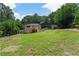 Exterior view of the modern home's spacious backyard and surrounded by lush greenery at 6456 Wright Ne Rd, Atlanta, GA 30328