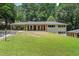 Charming single-story home featuring a covered carport and a large, lush front yard at 6456 Wright Ne Rd, Atlanta, GA 30328