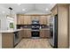 Modern kitchen features stainless steel appliances, light wood cabinets, and light hardwood flooring at 6456 Wright Ne Rd, Atlanta, GA 30328