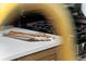 Close-up of kitchen counter with wooden spoon, grey towel, and stainless steel range at 6456 Wright Ne Rd, Atlanta, GA 30328