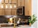 Kitchen with stainless steel microwave, pendant lighting, black backsplash and gold faucet at 6456 Wright Ne Rd, Atlanta, GA 30328