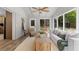 Sunroom with white-painted brick, neutral furnishings, ceiling fan, and lots of windows at 6456 Wright Ne Rd, Atlanta, GA 30328