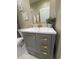 Stylish bathroom vanity featuring gray cabinets, gold hardware, and a modern sink at 2148 Martin Luther King Jr Sw Dr, Atlanta, GA 30310