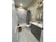 Bathroom with gray vanity, white marble tile in the shower, and stylish fixtures at 2148 Martin Luther King Jr Sw Dr, Atlanta, GA 30310