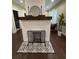 Stylish fireplace with a brick surround, wood mantle, and decorative accents at 2148 Martin Luther King Jr Sw Dr, Atlanta, GA 30310