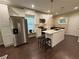 Modern kitchen with an island, stainless steel refrigerator, and white cabinetry at 2148 Martin Luther King Jr Sw Dr, Atlanta, GA 30310