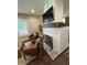 Living room with brick fireplace, mounted television, hardwood floors and leather chairs at 2148 Martin Luther King Jr Sw Dr, Atlanta, GA 30310
