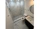 Elegant bathroom with marble-tiled shower, modern vanity, and stylish round mirror at 4356 Rockbridge Rd, Stone Mountain, GA 30083
