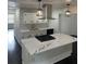 Bright kitchen with marble-look island, stainless vent hood, and subway tile backsplash at 4356 Rockbridge Rd, Stone Mountain, GA 30083