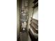 Utility room with hot water heater, shelving, and tile flooring at 4356 Rockbridge Rd, Stone Mountain, GA 30083