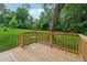 Wooden deck overlooking a private, lush backyard with mature trees at 4451 Flat Shoals Pkwy, Decatur, GA 30034
