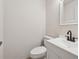 Cozy half-bathroom featuring modern fixtures, a white sink, and a toilet against a clean wall at 4451 Flat Shoals Pkwy, Decatur, GA 30034