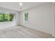 Well lit bedroom featuring multiple windows for natural light, and sleek wood-look flooring at 4451 Flat Shoals Pkwy, Decatur, GA 30034