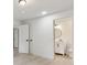 Bedroom view featuring a hallway and a view into the bathroom with a white vanity and round mirror at 4451 Flat Shoals Pkwy, Decatur, GA 30034