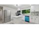 Bright kitchen featuring stainless steel appliances, white cabinetry, a center island, and stylish backsplash at 4451 Flat Shoals Pkwy, Decatur, GA 30034