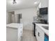 Corner kitchen view showcasing the island, stainless steel refrigerator, and modern black appliances at 4451 Flat Shoals Pkwy, Decatur, GA 30034