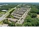 Wide aerial view of townhouses surrounded by lush green trees and a highway nearby at 4458 Dunblane Ave, Sugar Hill, GA 30518