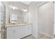 Bathroom featuring a dual sink vanity with white cabinets and a view into another room at 4458 Dunblane Ave, Sugar Hill, GA 30518